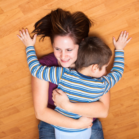 Portrait of happy mother and son huggingの写真素材