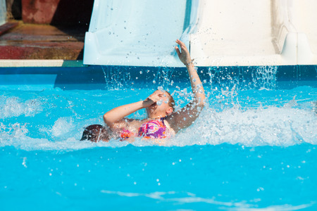 People having fun, sliding at water park.の写真素材