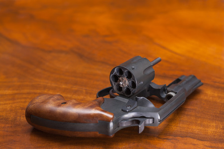 Cylinder revolver handgun over wooden background.の写真素材