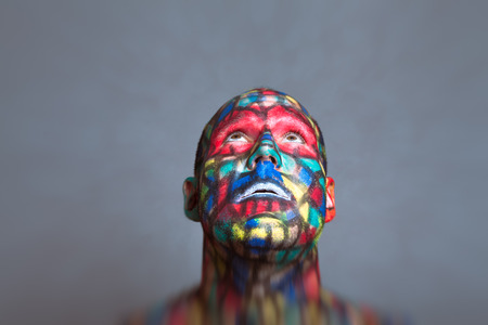 Superhero looking up, colorful face art with tilt shift and motion blur effect.の写真素材