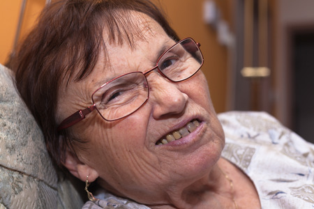 Closeup of a senior woman grimacing and frowning.の写真素材