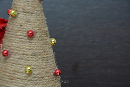 Christmas tree toys on red napkin. Mandarins and candles on the table. A fur-tree branch and fruit on a New Years table.の写真素材