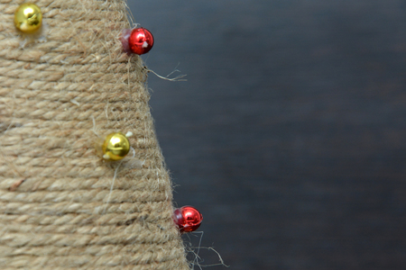 Christmas tree toys on red napkin. Mandarins and candles on the table. A fur-tree branch and fruit on a New Years table.の写真素材