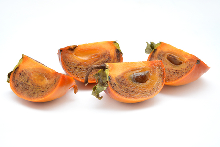 fruit on white background pomegranate grain grenade and persimmonの写真素材