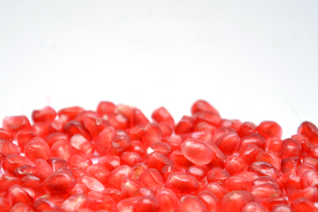 fruit on white background pomegranate grain grenade and persimmonの写真素材