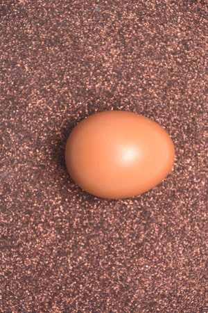 Overhead view of brown chicken eggs in an open egg carton isolated on yellow. Fresh chicken eggs...