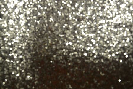 Abstract warm bokeh effect on blue background. Gold glitter lights.の写真素材