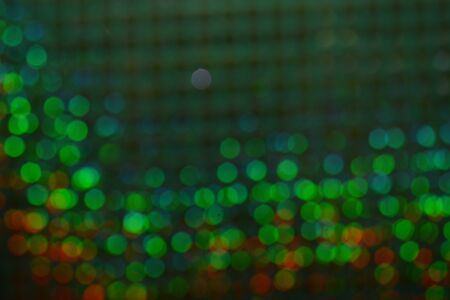 Abstract warm bokeh effect on blue background. Gold glitter lights.の写真素材