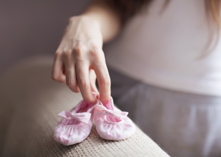 Woman's hand hold babe's booteesの写真素材