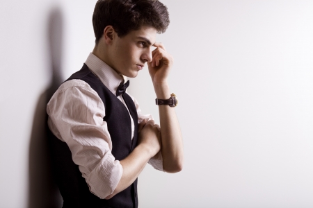 fashion brunette guy near the wallの写真素材