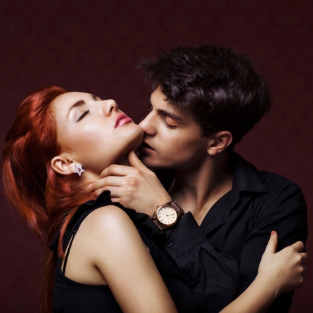 portrait of happy fashion couplehugging and kissing each otherの写真素材