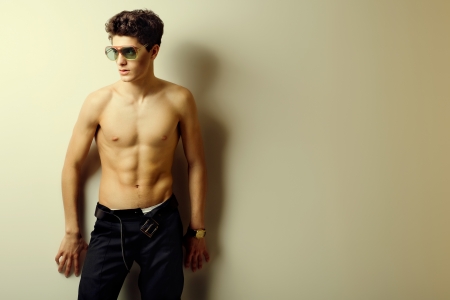 fashion brunette man with a naked torso  studioの写真素材