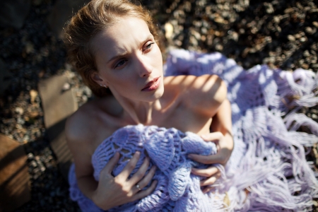 fashion model laying on the ground in shawl, outdoor shot の写真素材