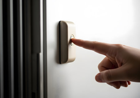 Close-up of woman's hand turning on the light switch.の素材