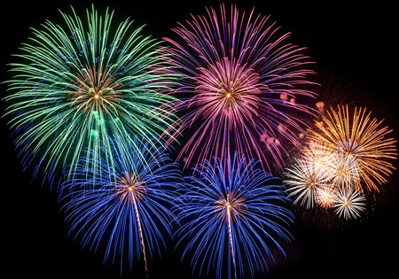 Colorful fireworks of various colors over night sky for celebration background.の素材