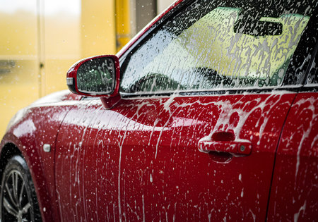 Close up of red car with water drops on the windshield. Shallow depth of fieldの素材