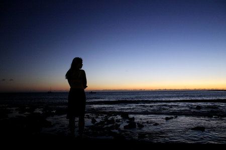 girl looking at sunset over ocean