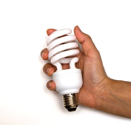 Energy saving fluorescent spiral light bulb in hand isolated on white background