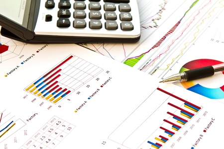 Pen and calculator on financial Graphsの写真素材