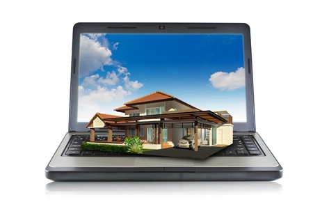 House on laptop isolated on white backgroundの写真素材