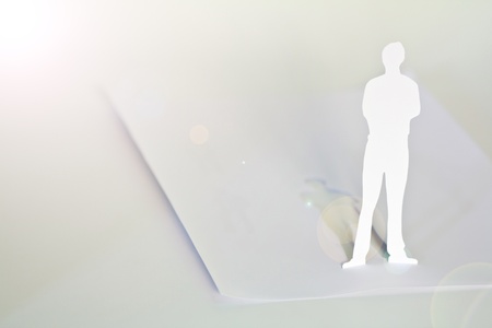 Close up of people cut out of paper on tableの写真素材