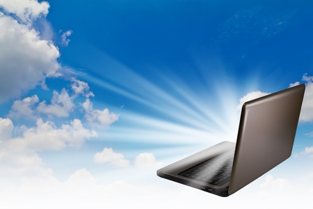 Laptop in sky with light out.の写真素材