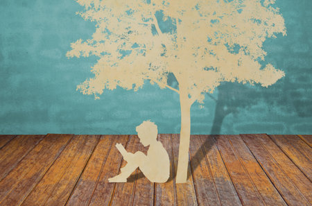Paper cut of children read a book under treeの写真素材