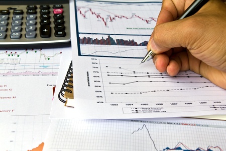 Hand write on Various financial charts on the table with calculatorの写真素材