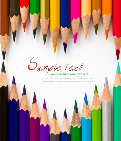 Colored pencils arrange as heart - isolated on the white backgroundの写真素材