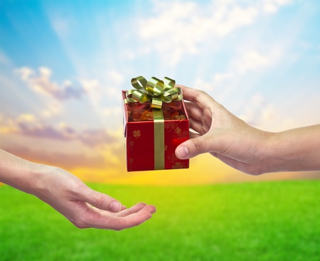 "Give and take" Gift box on hand to handの写真素材