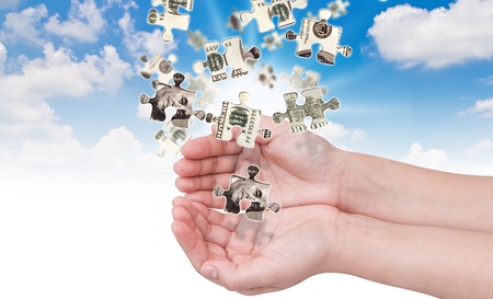 Hands and dollar money puzzleの写真素材