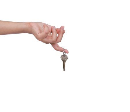 Human hand and key isolated on white backgroundの写真素材