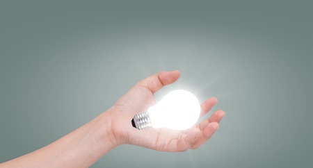 Women hand with lamp bulbの写真素材