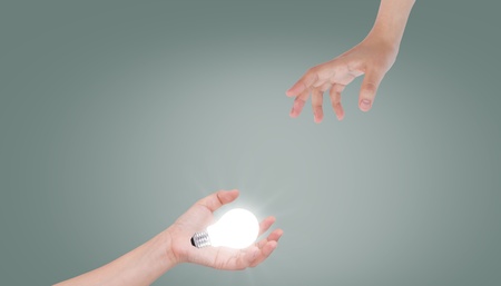 Women hand with lamp bulbの写真素材