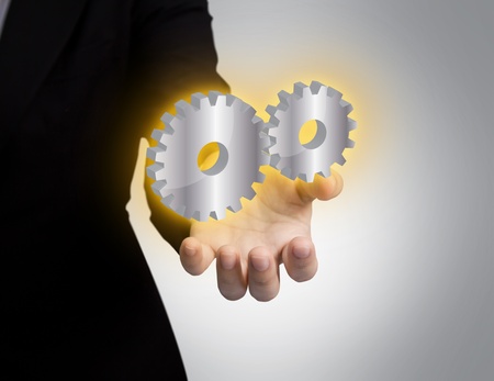 Businessperson holding gears of success in handの写真素材