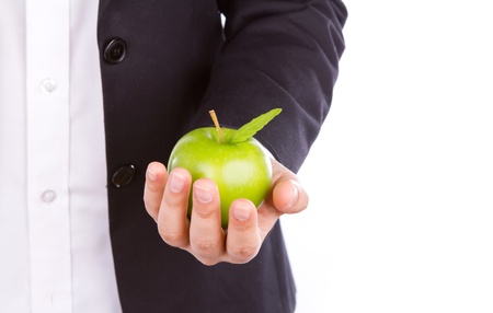 Businessman hand with a green apple in his hand isolate on white backgroundの写真素材