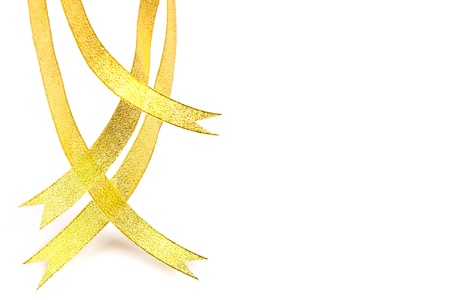 Gold ribbons hanging down on white backgroundの写真素材