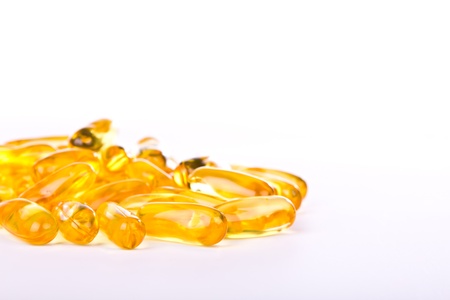 Capsules of fish oil and vitamins on white background.の写真素材