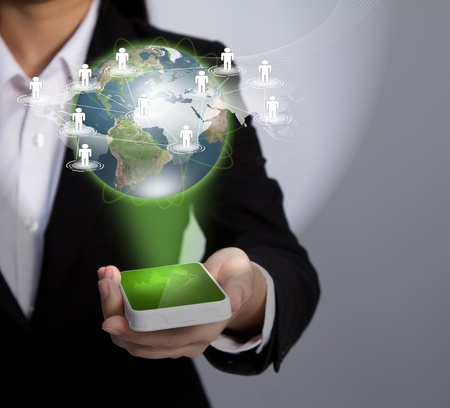 Hand holding a phone show Earth and social networkの写真素材