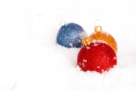 Blue ,red and gold christmas balls with snowの写真素材