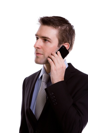 Portrait of young business man on the phone against white backgroundの写真素材