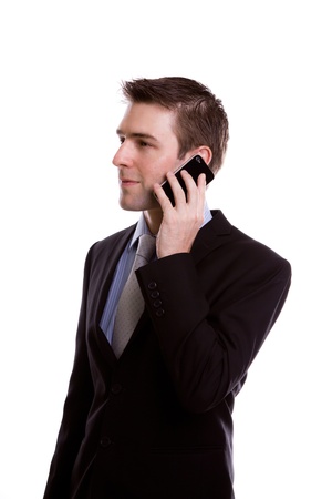 Portrait of young business man on the phone against white backgroundの写真素材