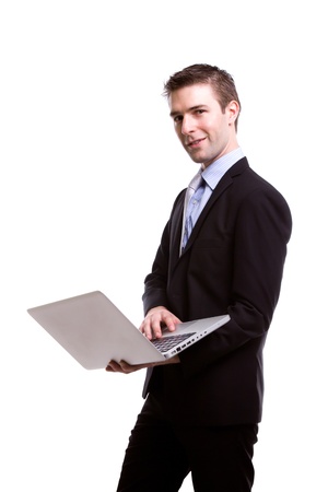 Portrait of young business man with laptop against white backgroundの写真素材