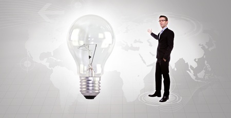 Portrait of young business man holding a light bulbの写真素材