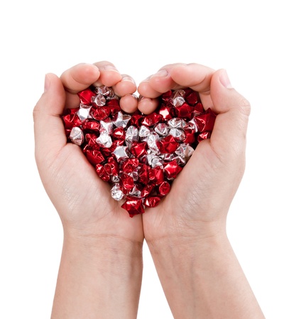 Hands forming heart hold many small starの写真素材