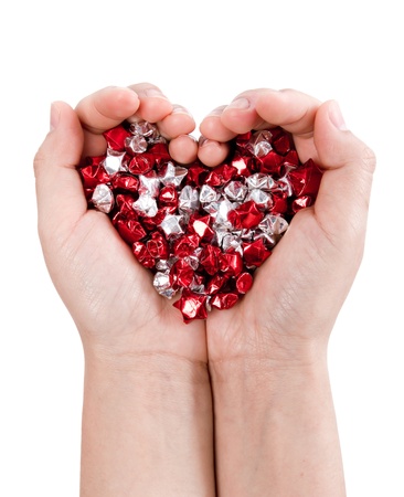 Hands forming heart hold many small starの写真素材