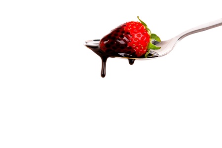 Strawberry on spoon with chocolateの写真素材