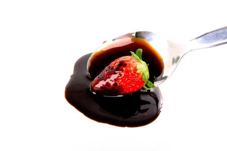 Strawberry on spoon with chocolateの写真素材
