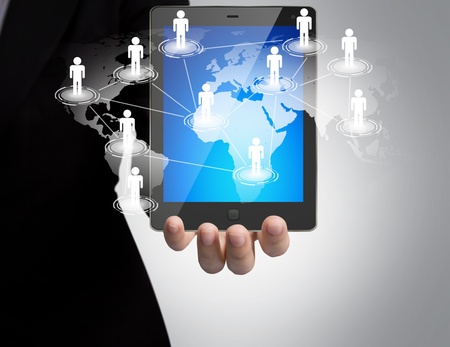 Hand holding a touch pad show Earth and social networkの写真素材