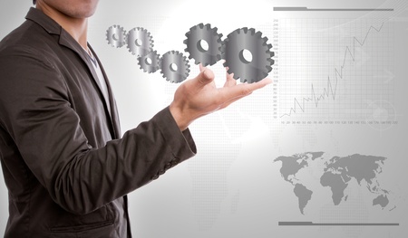 Businessperson holding gears of success in handの写真素材